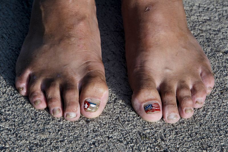 FILE PHOTO: Cuban migrant shows her toes decorated with the