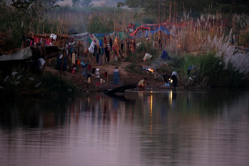 Myanmar refugees settle temporarily on the Moei River Bank, in
