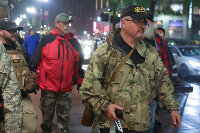 Stewart Rhodes of the Oath Keepers holds a radio as