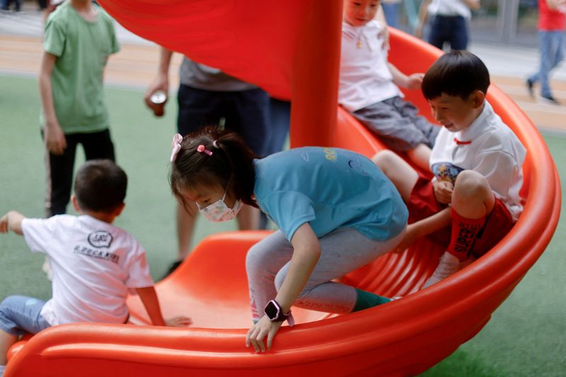 FILE PHOTO: Children play at a playground inside a shopping