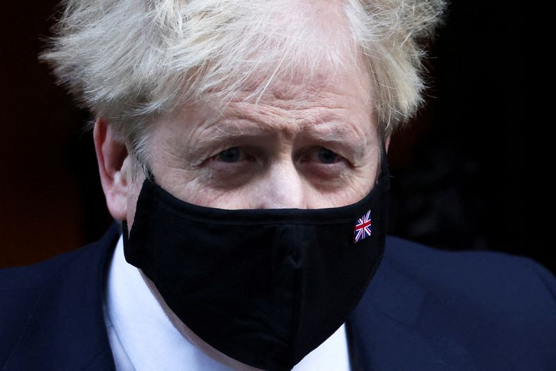 FILE PHOTO: British Prime Minister Johnson walks outside Downing Street