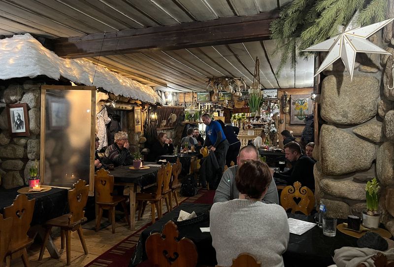 FILE PHOTO: People sit and eat at Karczma Obrochtowka restaurant,