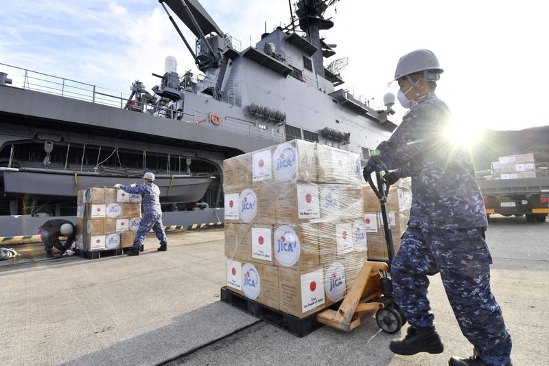 Japan Self-Defense Forces officers load relief supplies to be deployed