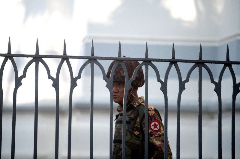 FILE PHOTO: A Myanmar soldier looks on as he stands
