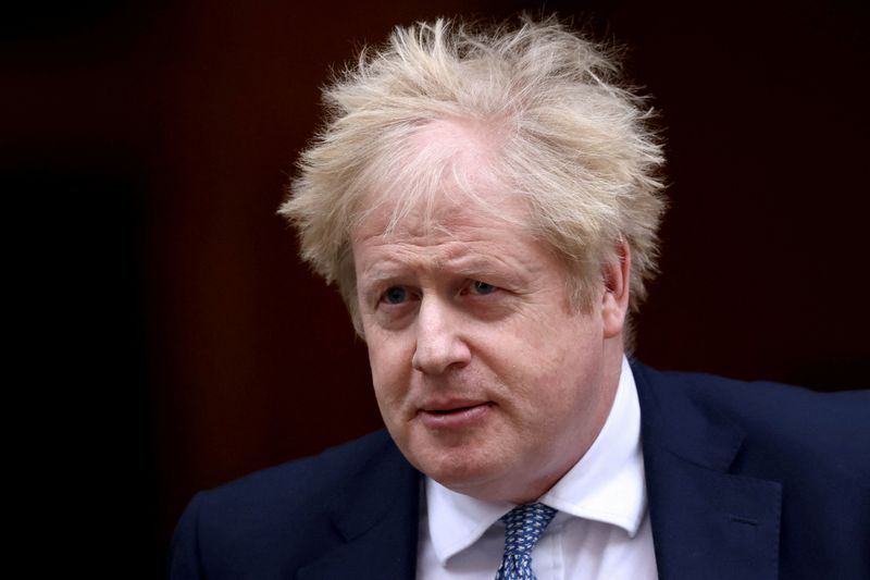 FILE PHOTO: British PM Johnson walks outside Downing Street in