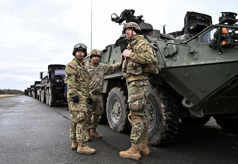 Soldiers of the U.S. 2nd Cavalry Regiment prepare their gear