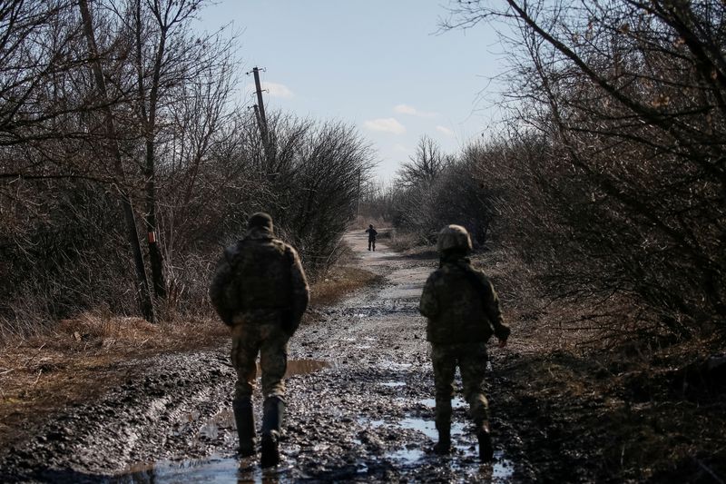 Ukrainian service members are seen on the front line near