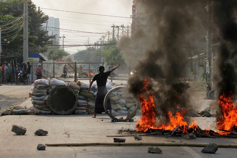 FILE PHOTO: Demonstrators gather behind barricades during a protest against
