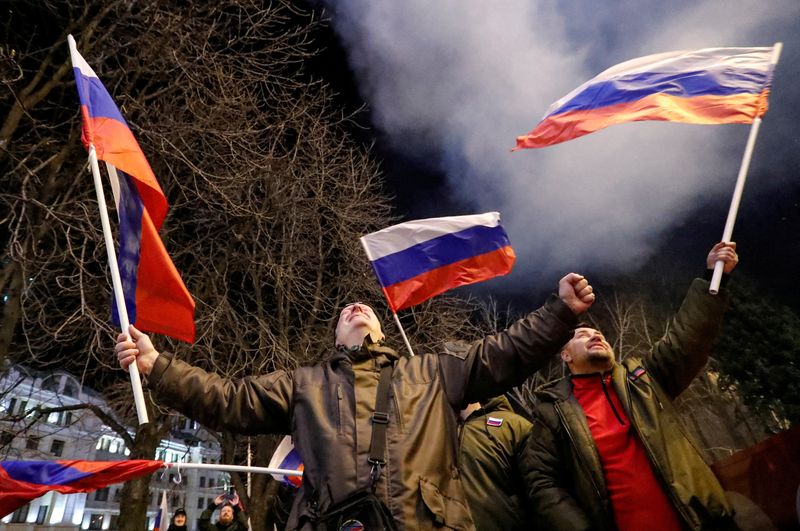 FILE PHOTO: Pro-Russian activists react on a street in Donetsk