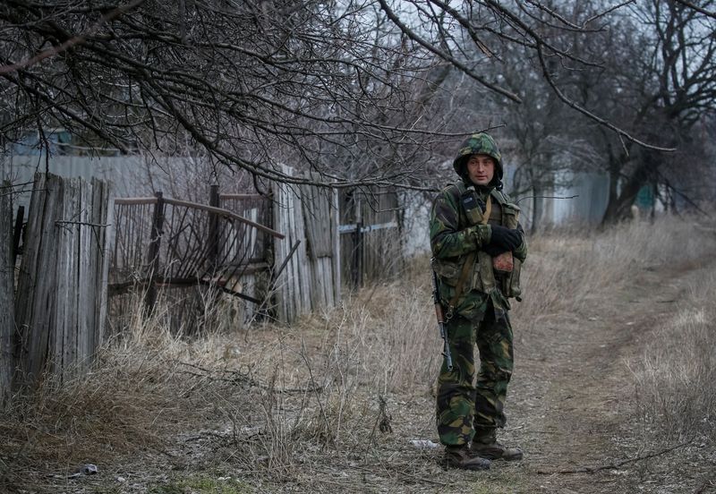 Ukrainian service member stands on the front line near the