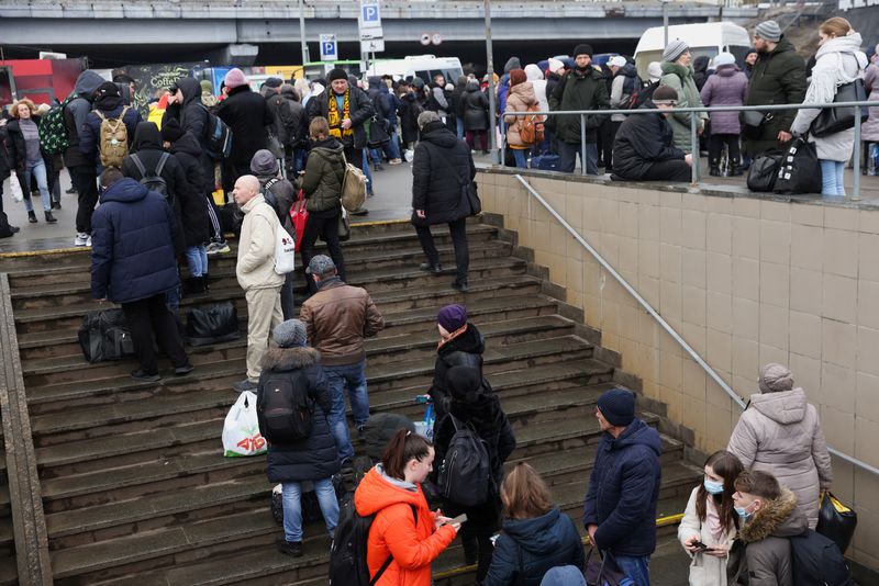 People wait at a bus station in Kyiv after Russian