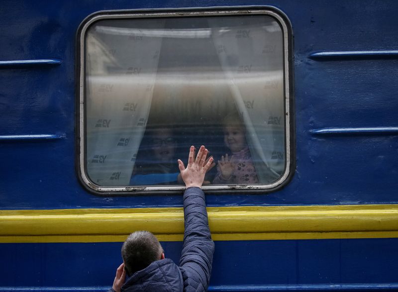 People wait to board an evacuation train at Kyiv central