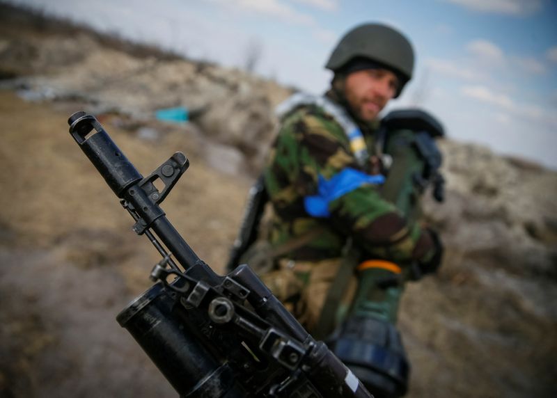 A Ukrainian service member stands at a position on the