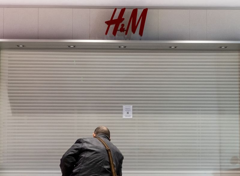 FILE PHOTO: A man looks at a closed H&M store