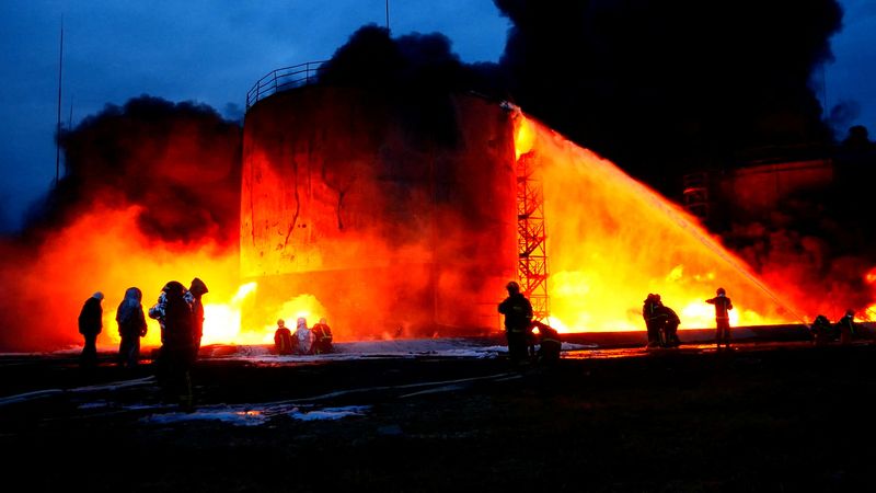 Rescuers work at a site of fuel storage facilities hit