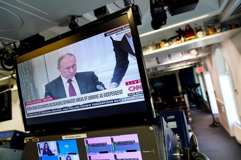 FILE PHOTO: Russian President Vladimir Putin appears on a screen