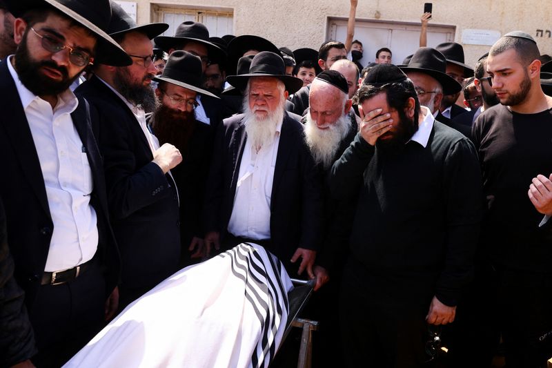 Friends and family mourn at the funeral of Avishai Yehezkel