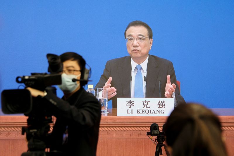 Chinese Premier Li Keqiang attends a news conference via video