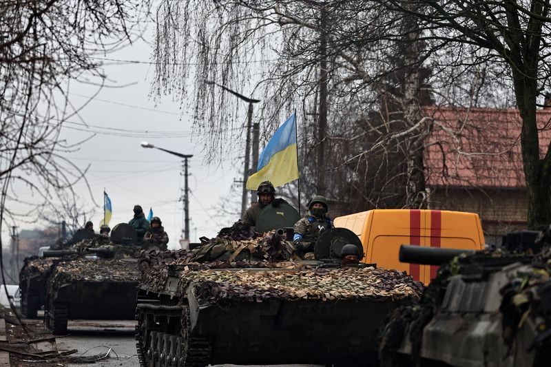 Ukrainian soldiers are pictured on their tanks as they drive