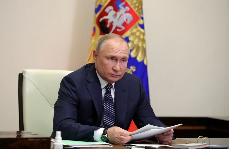 FILE PHOTO: Russian President Vladimir Putin chairs a meeting outside