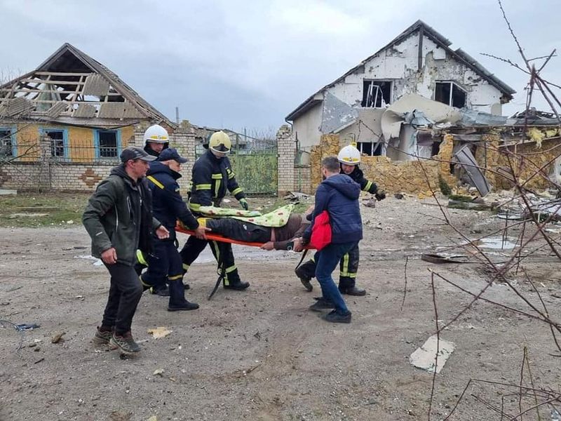 Rescuers carry a civilian injured during shelling in Mykolaiv region