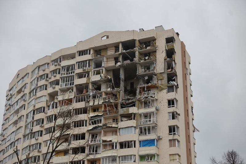 A view shows an apartment building damaged by heavy shelling