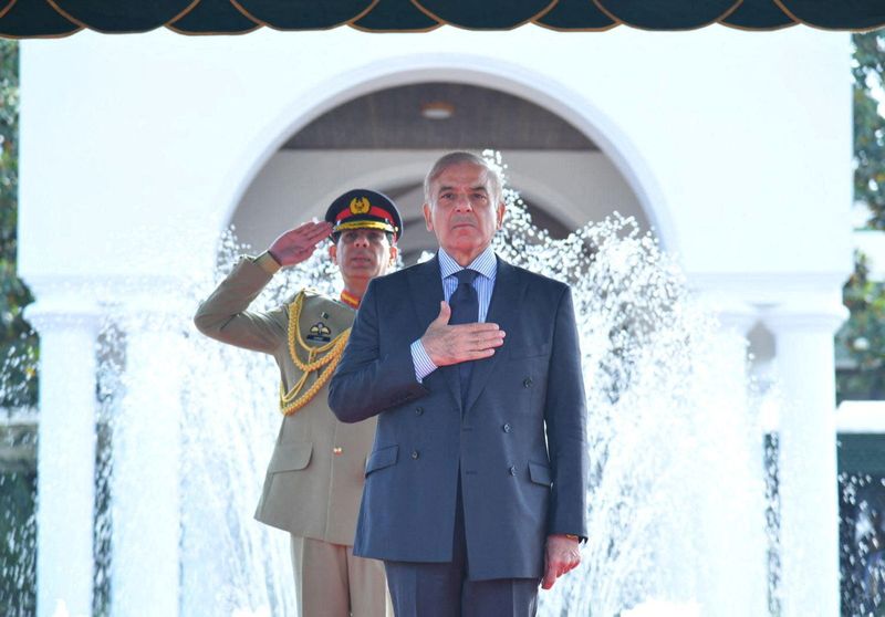 Pakistan’s Prime Minister Shehbaz Sharif gestures during the guard of