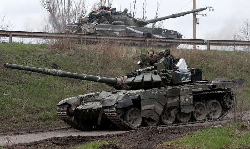 Tanks of pro-Russian troops drive along a road near Mariupol