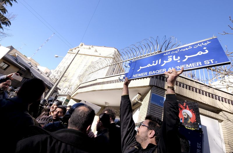 FILE PHOTO: Iranian protester holds up a street sign with