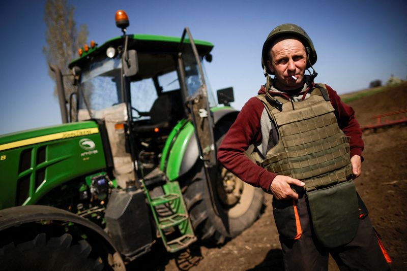 Ukrainian farmer wears body armour to plow frontline fields, in