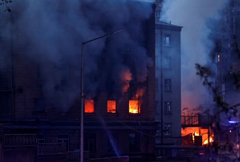 Fire burns in a building after a shelling, amid Russia’s