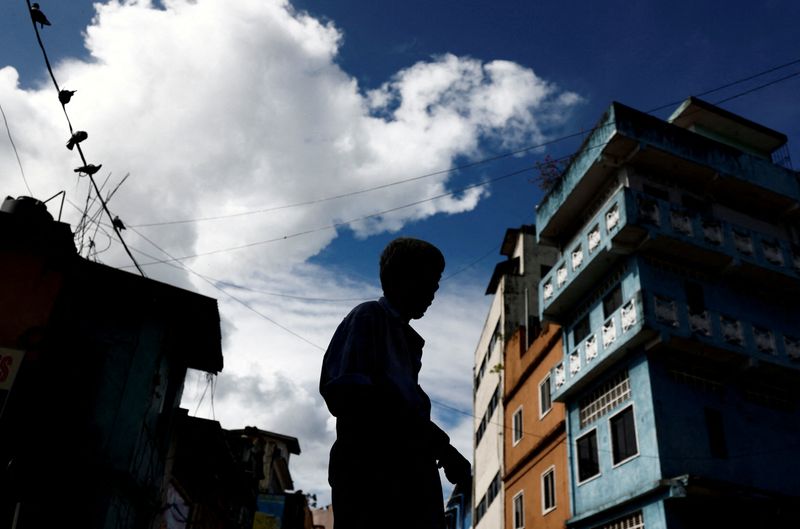 FILE PHOTO – A worker stands in front of a