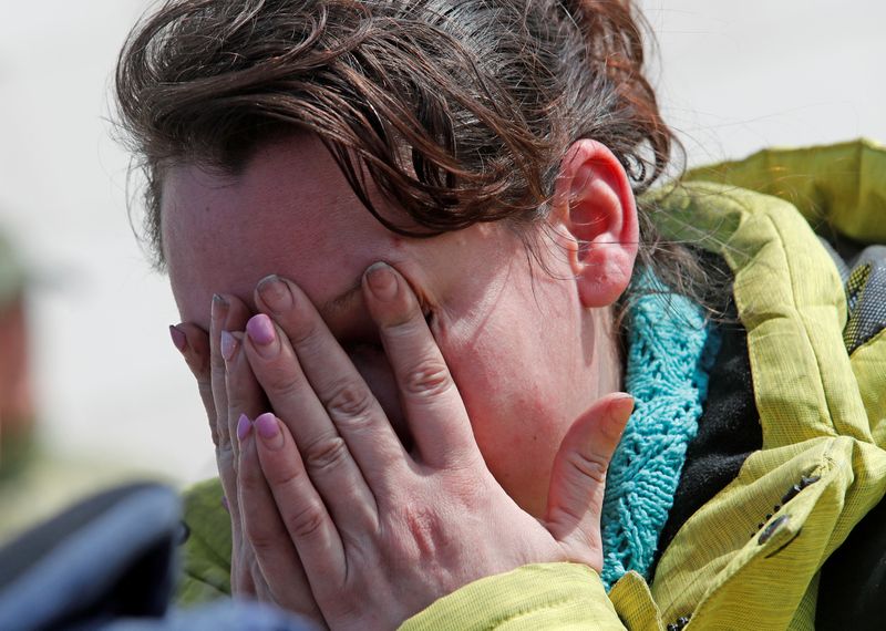 A woman reacts at a temporary accommodation centre in Bezimenne