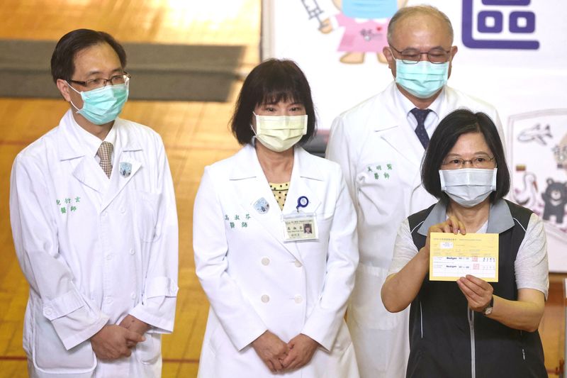 FILE PHOTO: Taiwan’s President Tsai Ing-wen shows her vaccination document