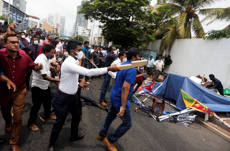 FILE PHOTO: Sri Lanka’s ruling party supporters storm anti-government protest
