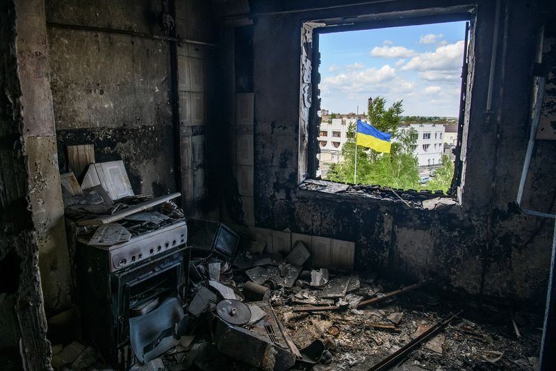 Ukrainian national flag is seen through the window of an