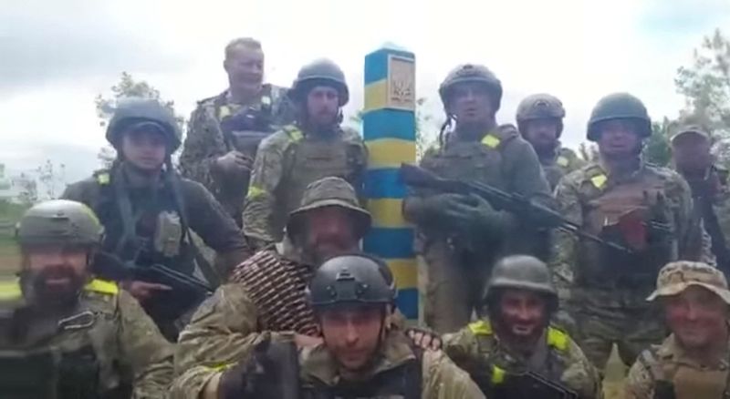 Ukrainian troops stand at the Ukraine-Russia border in what was
