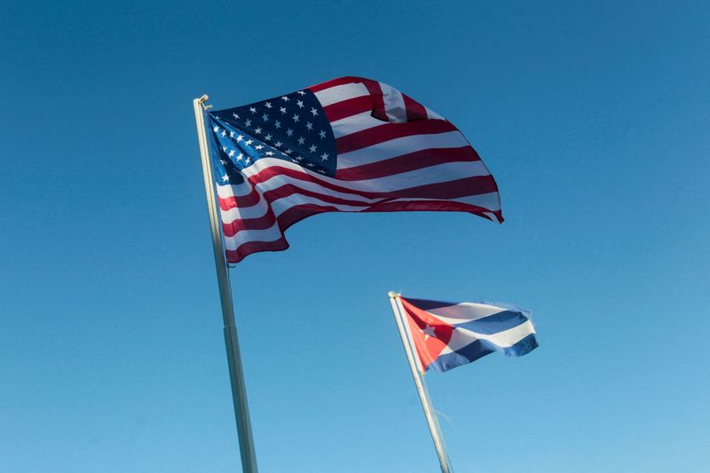 FILE PHOTO: U.S. and Cuban flags hang outside a hotel