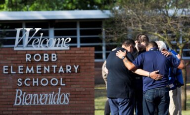 People react after a mass shooting at Robb Elementary School