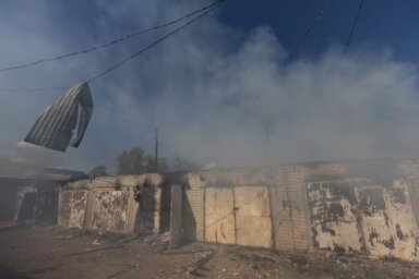 FILE PHOTO: A garage burns following a military strike on