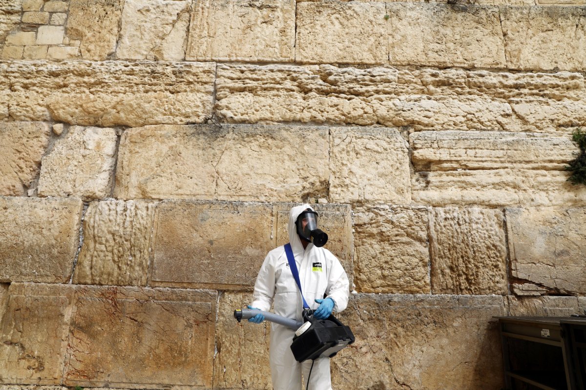 A labourer sanitizes the stones of the Western Wall as