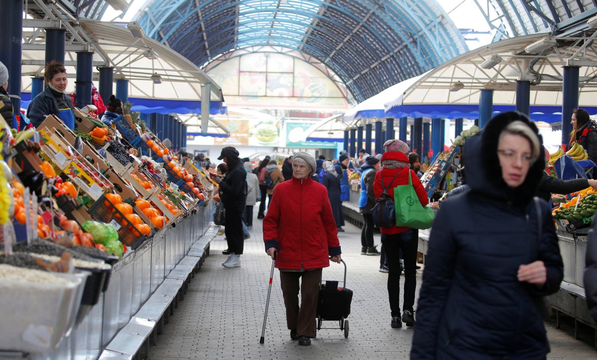 People shop at the largest food market “Komarovski” amid the
