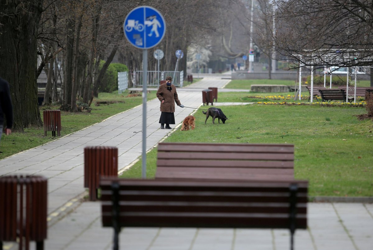 FILE PHOTO: Woman walks her dogs in an empty park,