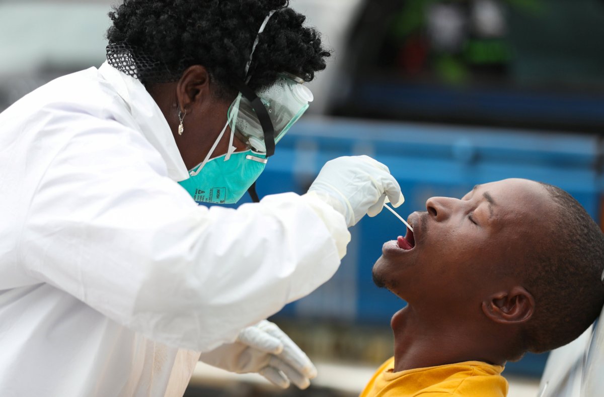 A member of medical staff swabs the mouth of a