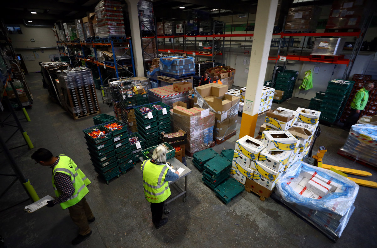 Volunteers sort and check food quality at the FareShare food