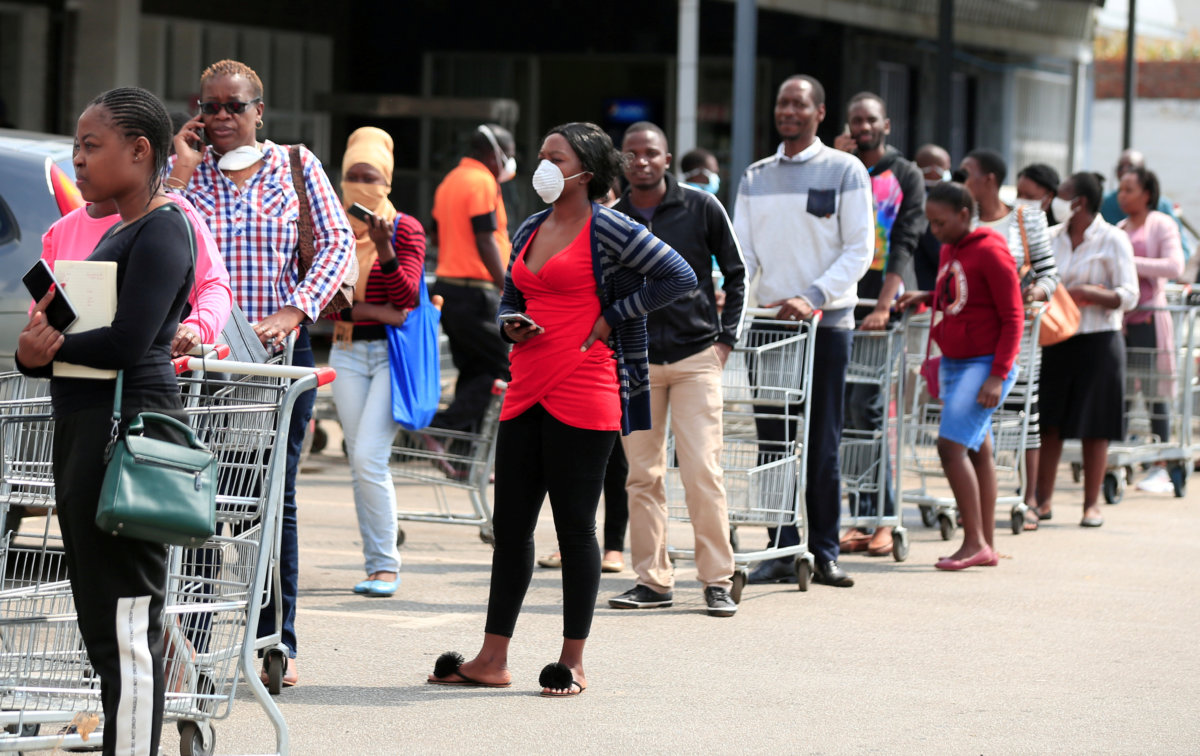 FILE PHOTO: People queue to shop ahead of a nationwide