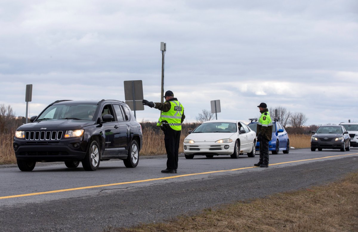 Surete du Quebec police officers set up a checkpoint for