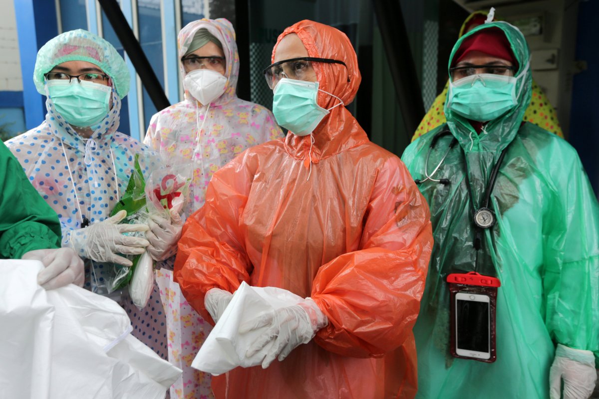 Medical workers wearing disposable raincoats as their protective suits to