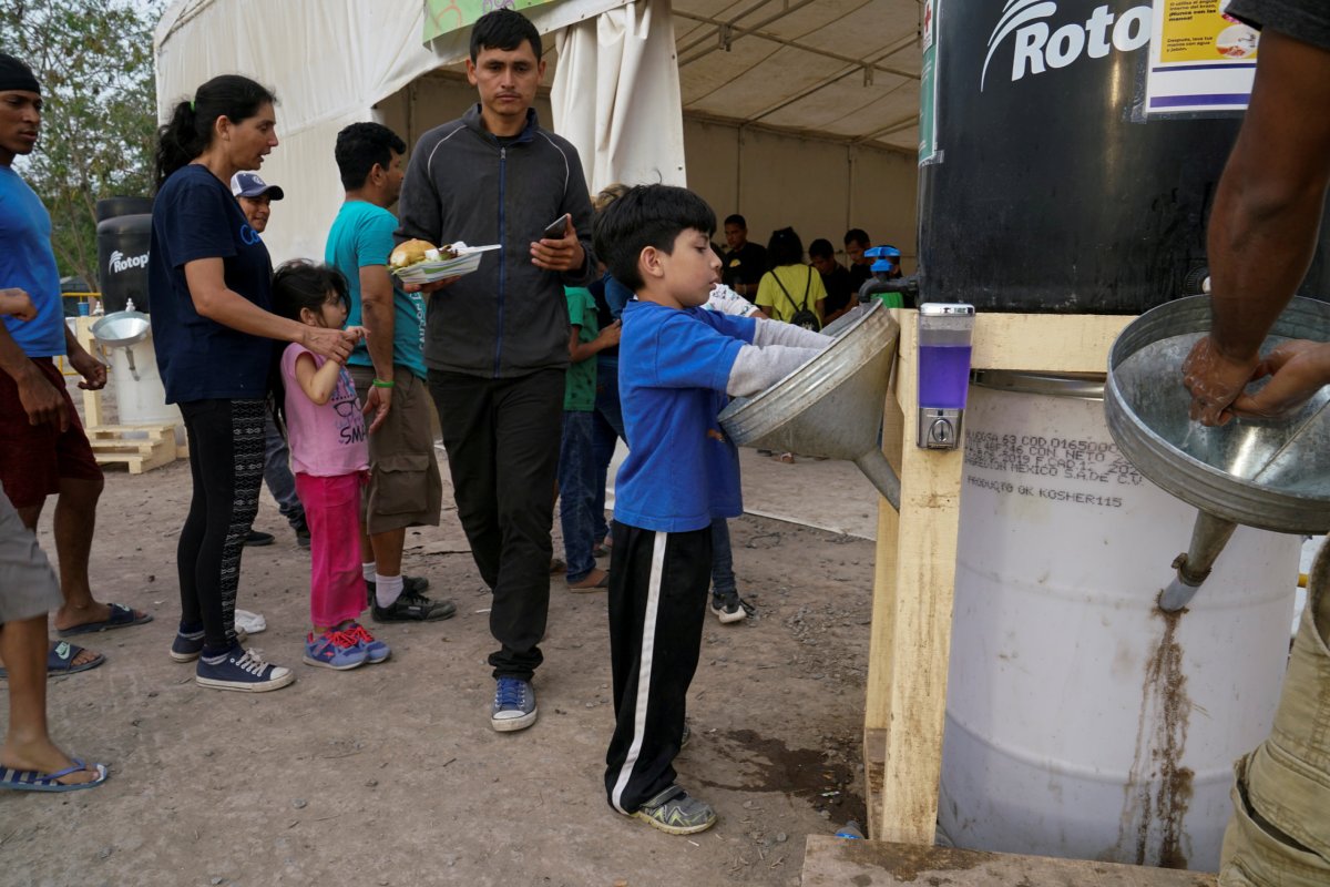 FILE PHOTO: An asylum-seeking child washes his hands at a
