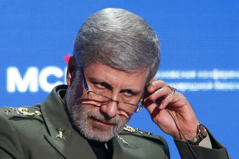 FILE PHOTO:  Iranian Defence Minister Amir Hatami adjusts a